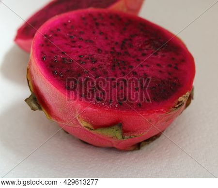 Close Up Of Section Through Juicy Dark Pink Pitaya Fruit
