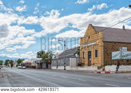 Oudtshoorn, South Africa - April 5, 2021: A Street Scene, With Businesses, In Oudtshoorn In The West