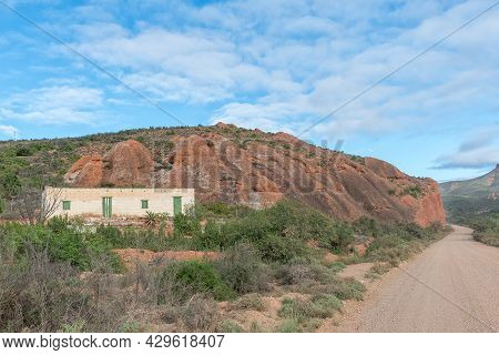 Red Stone Hills, South Africa - April 6, 2021: A Road, Farm And Mountain Landscape At Red Stone Hill