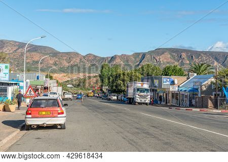 Calitzdorp, South Africa - April 6, 2021: A Street Scene, With Businesses, People And Vehicles, In C