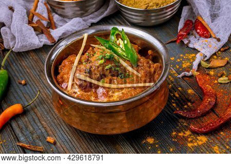 chicken tikka masala Indian food on wooden background with spices