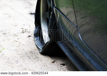 Punctured Wheel Of A Modern Car On The Road. Car Tire Puncture.