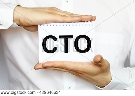 A Businessman In A White Shirt Shows A Business Card With Text Cto , Copy Space, Business Concept