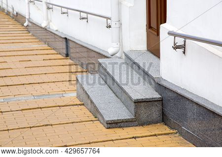 Granite Threshold At Entrance Door Made Of Brown Wood And White Facade With Plinth Stone Cladding Of