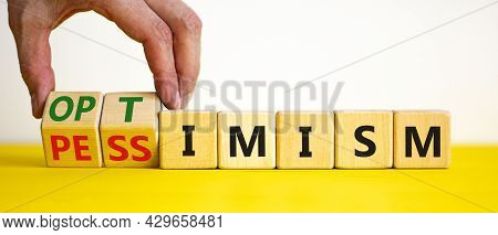 Pessimism Or Optimism Symbol. Businessman Turns Cubes And Changes The Word 'pessimism' To 'optimism'