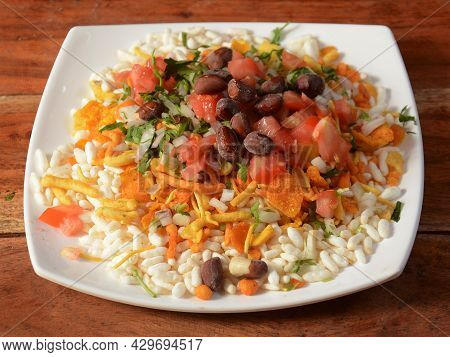Bhel Puri, A Famous Midday Snack In India, Served Over A Rustic Wooden Background, Selective Focus