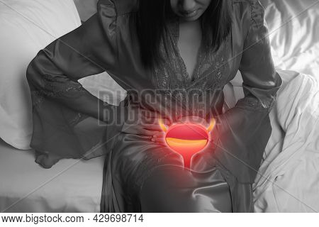 A Woman Having Urethritis And Urinary Incontinence. Female In A Satin Nightgown With Hands Holding H