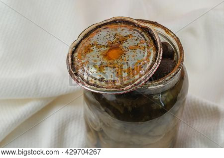 Opened Glass Jar With Homemade Pickled Mushrooms. Rusty Tin Lid With Black Spots. Spoiled Blackened 