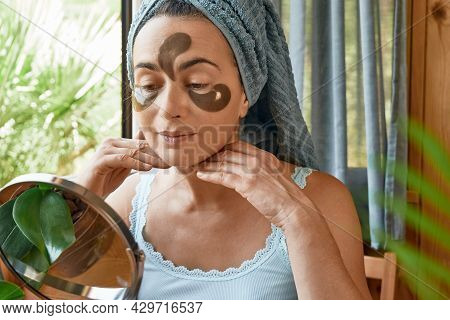 Skincare Routine. Middle Age Woman Touching Her Face With Wrinkles And Hydrogel Under-eye Patches, L