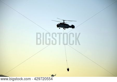 Russian KA-32 helicopter draws water from the sea to extinguish a forest fire. 30 July, 2021. Marmaris,Turkey