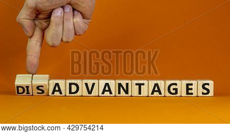 Advantages Or Disadvantages Symbol. Businessman Turns Wooden Cubes, Changes The Word Disadvantages T