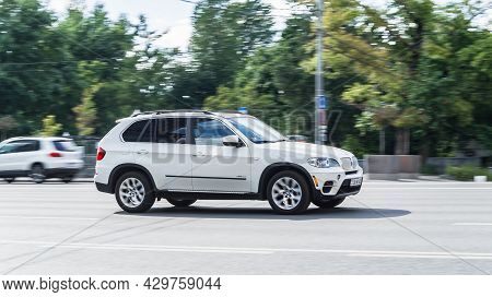 Moscow, Russia - August 2021: White Bmw X5 E70 Driving On The Road With Blurred City Background