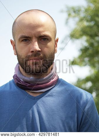 Bust Portrait Of A White-skinned Man. Bald Man With A Beard And A Buff On His Neck. Gaze.