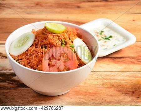 Tawa Pulao Cooked With Masala Spices, Served Over A Rustic Wooden Background, Selective Focus