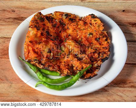 Churchur Naan, Isolated Over A Rustic Wooden Background, Selective Focus
