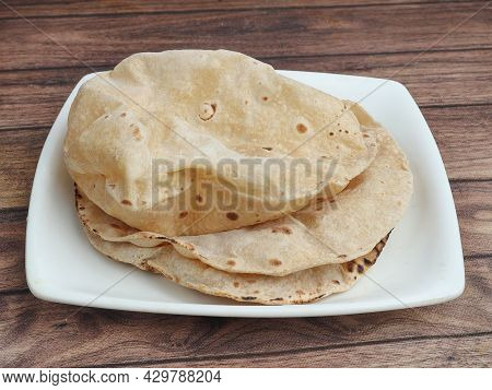 Phulka, Isolated Over A Rustic Wooden Background, Selective Focus