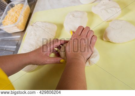 Female Hands Knead A Yeast Dough, Making Preparetion To Bake A Pizza Bread.