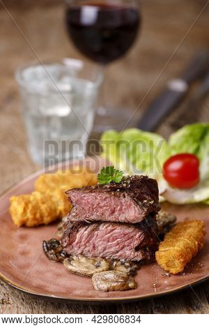 Steak Slices With Croquettes And Mushrooms And Wine
