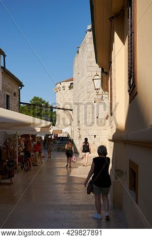 Krk, Croatia - August 10, 2021: Historical Alley In The Old Town Of Krk In Croatia. In The Backgroun