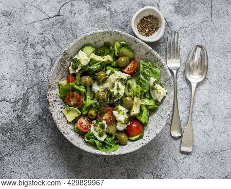 Fresh Vegetable Salad With Tomatoes, Avocado, Lettuce, Cucumbers, Burrata And Pesto Sauce Dressing O