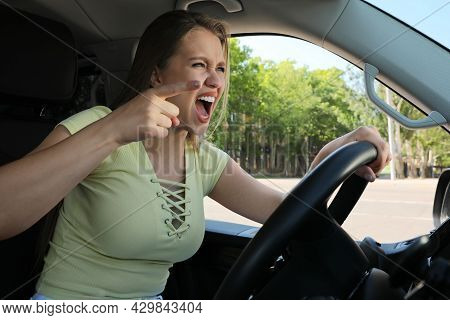 Emotional Woman In Car. Aggressive Driving Behavior