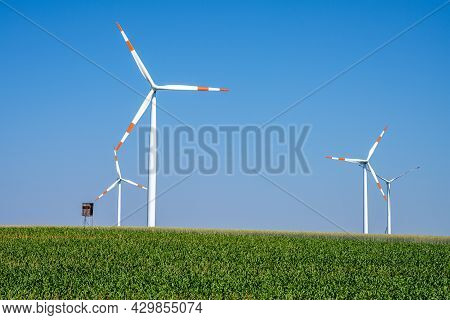 Modern Wind Turbines In A Grainfield Seen In Germany
