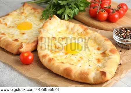 Fresh Delicious Adjarian Khachapuris Served On Grey Table