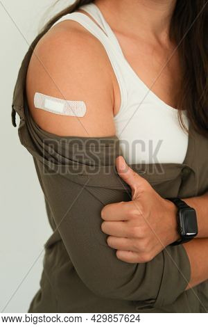 Coronavirus Vaccination Advertisement. Vaccinated Woman Showing Arm With Plaster Bandage After Covid