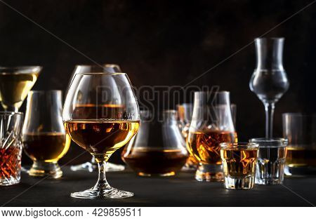 Strong Alcohol Drinks, Hard Liquors, Spirits And Distillates Iset In Glasses: Cognac, Scotch, Whiske