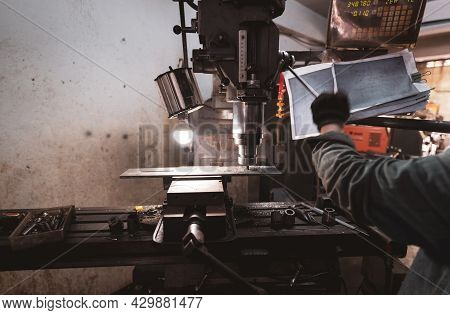 Milling Machine Working Near Worker With Gloves. Tool For Cut Metal Workpiece. Vertical Milling Mach