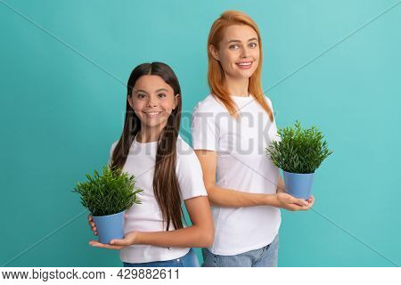 Adoptive Family Of Adopted Daugher Child And Woman Mother Smile Holding Pot Plants, Foster