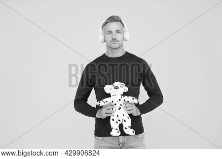 Childish And Infantile. Childish Adult Hold Toy Dog Yellow Background. Imaginative Friend. Pretend P