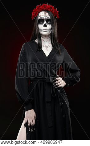 Young Woman With Calavera (sugar Skull) Makeup. The Witch Girl With Muertos (muerte) Greasepaint In 