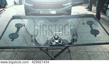 Glass Windscreen Or Windshield Before Installation On Car In Service Station Garage.