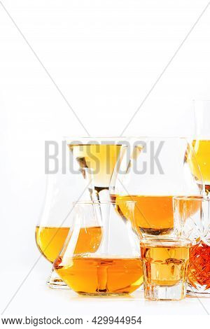 Strong Alcohol Drinks, Hard Liquors, Spirits And Distillates Iset In Glasses: Cognac, Scotch, Whiske
