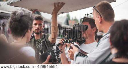 Behind The Scenes. Film Crew Team Shooting Movie Scene On Outdoor Location. Group Filmmaking Set Pro
