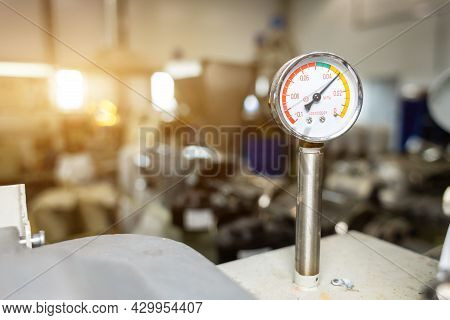 Close-up Of A Monometer Against The Background Of Units And Equipment In Production