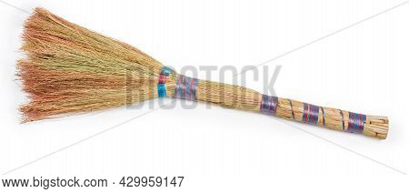 Short Handle Broom Made With Natural Sorghum Tassels On A White Background, Top View Close-up