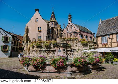 Eguisheim, Alsace, France July 2021, Traditional Colorful Halt-timbered Houses In Eguisheim Old Town
