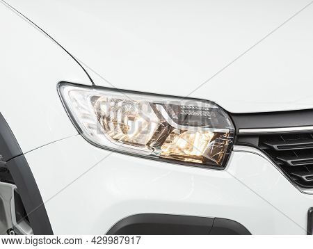 Novosibirsk, Russia - July 15, 2021:   Renault Logan Crossway,  Close Up Of The Car Headlights. Exte