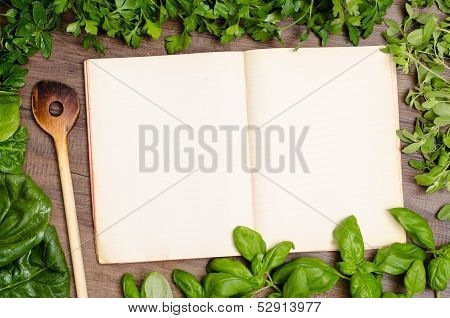 Green Herbs As Frame Around A Cookbook