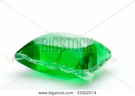 One green laundry detergent capsule