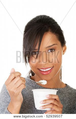 Young beautiful woman eating yogurt as healthy breakfast or snack. Isolated on white