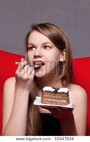 a Cheerful woman eating chocolade a pie