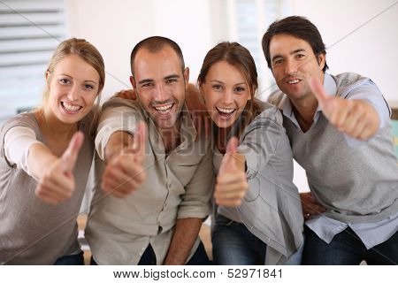 Business team shwoing thumbs up