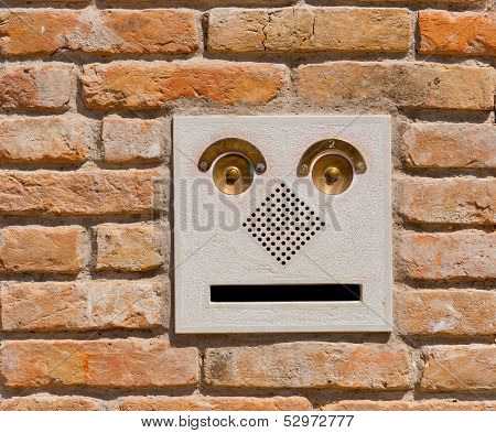 A Modern Intercom Doorbell  Panel On Old Brick Wall.