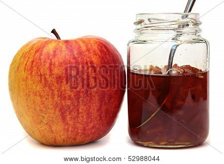 Apples and glass jar with jam