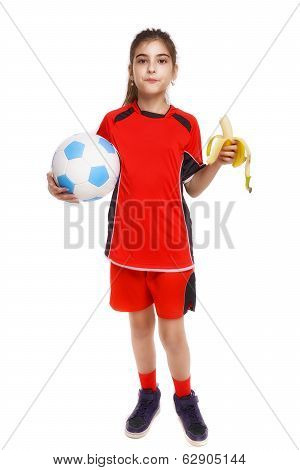 Young Soccer Player Eating Banana As Halftime Snack