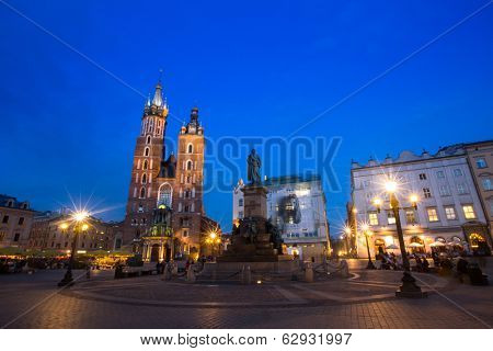KRAKOW, POLAND - APR 7, 2014: St. Mary's Church on Rynek Glowny (Market Square) in night time. Rynek Glowny - roughly 40,000 m2 is largest medieval town square in Europe.
