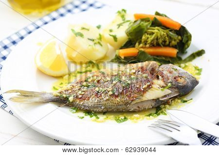 very fresh seabream fish grilled with turnip greens - traditional food from Portugal